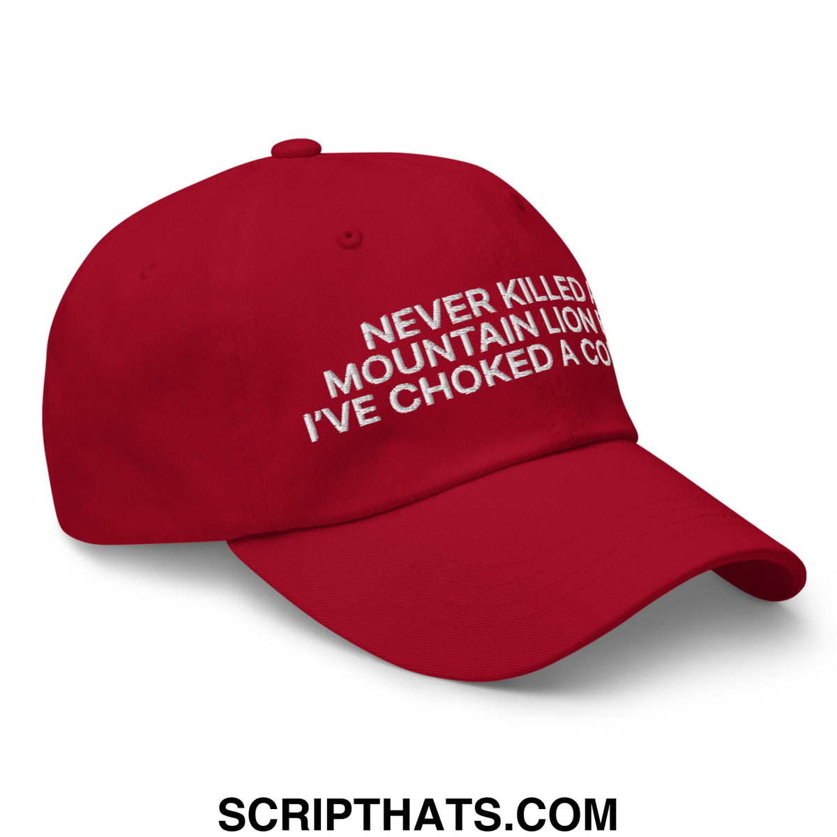 Red unstructured dad hat with white embroidered never killed a mountain lion ive choked a cougar text