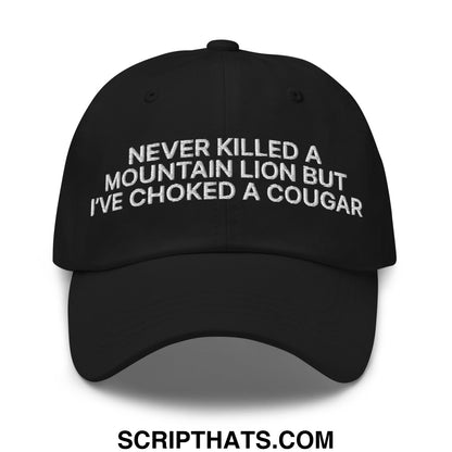 Black unstructured dad hat with white embroidered text never killed a mountain lion but ive choked a cougar