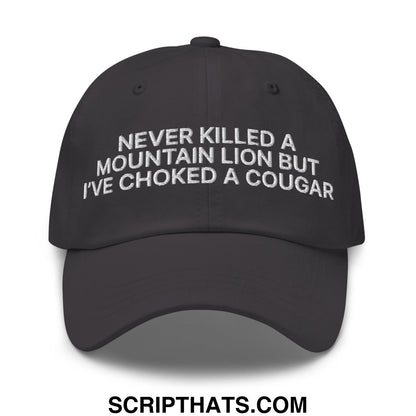 Black unstructured dad hat with white embroidered text never killed a mountain lion but ive choked a cougar