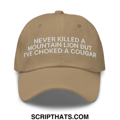 Tan embroidered unstructured dad hat with white text never killed a mountain lion but ive choked a cougar