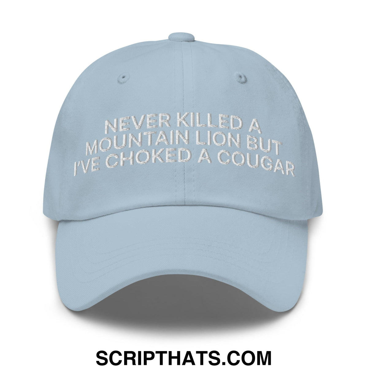 Light blue unstructured dad hat with white embroidered text never killed a mountain lion but ive choked a cougar
