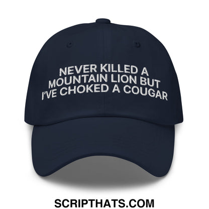 Navy blue unstructured dad hat with white embroidered text never killed a mountain lion but ive choked a cougar