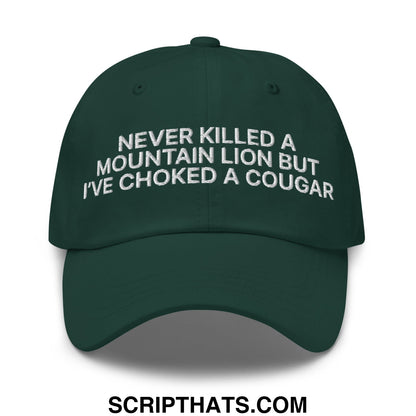 Dark green unstructured dad hat featuring white embroidered text never killed a mountain lion but ive choked a cougar