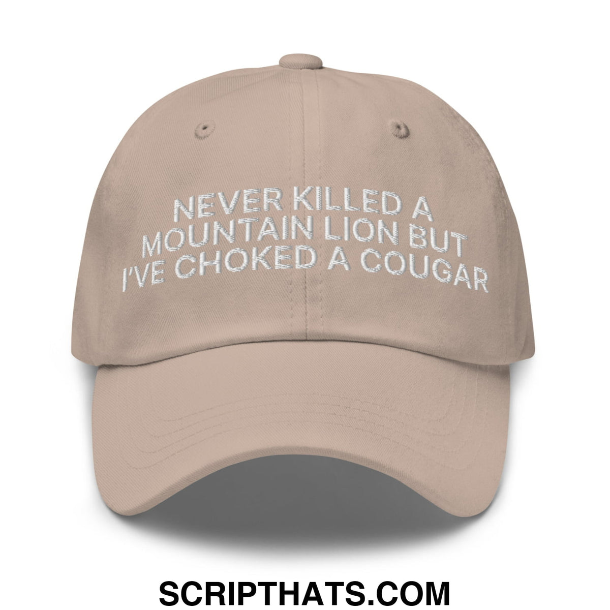 Beige unstructured dad hat embroidered with white text never killed a mountain lion but ive choked a cougar