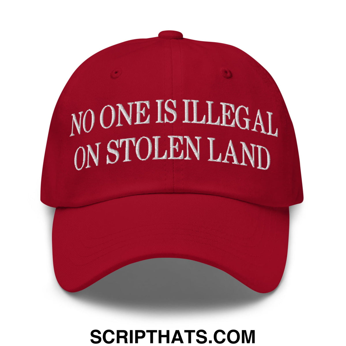 Red unstructured dad hat with white embroidered text no one is illegal on stolen land for casual wear