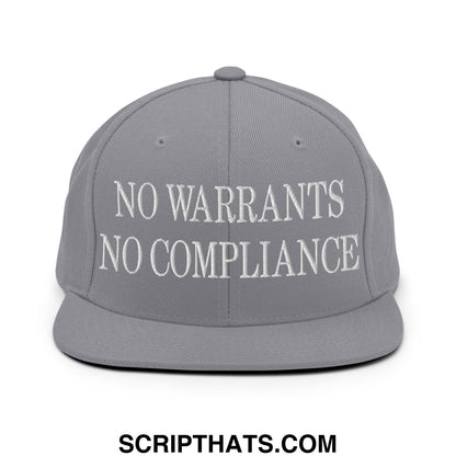 Gray snapback cap with white embroidered no warrants no compliance text and flat bill brim design