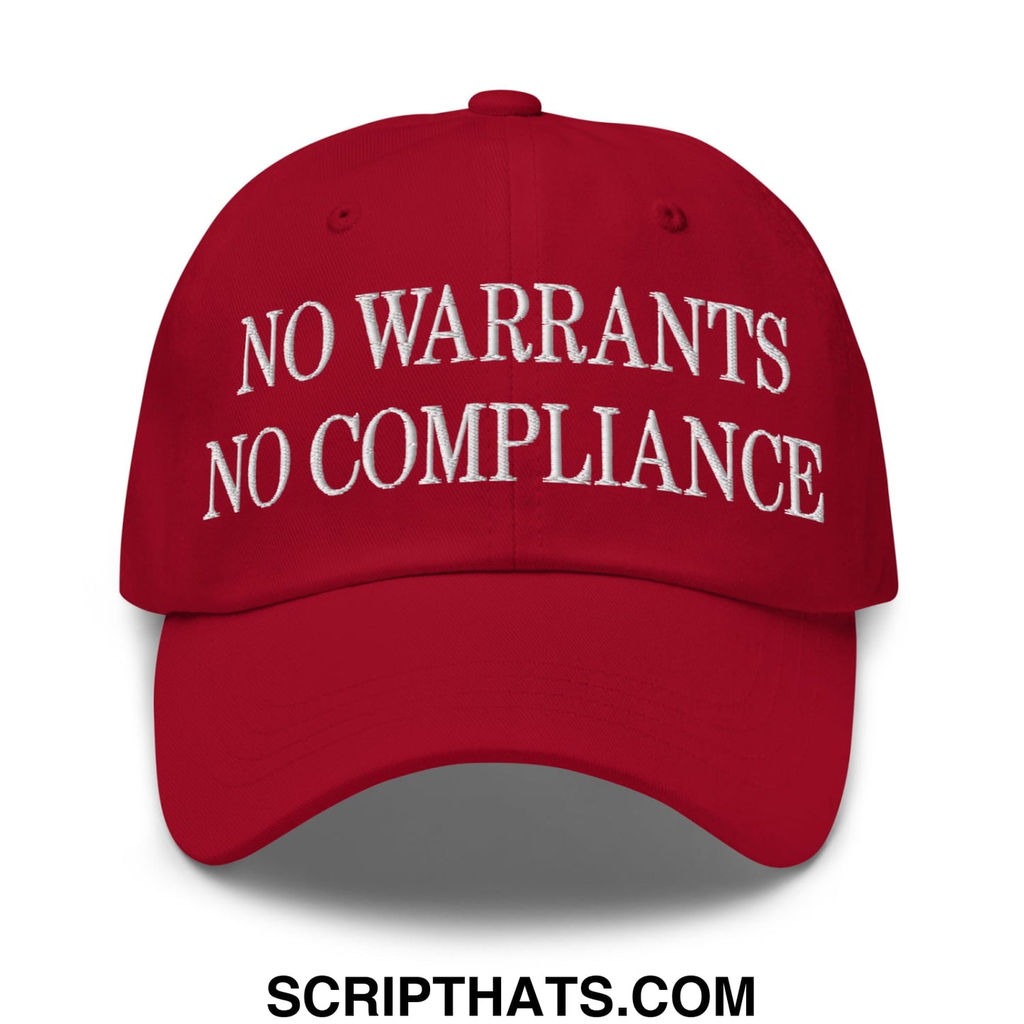 Red unstructured dad hat with white embroidered no warrants no compliance text on front for casual wear