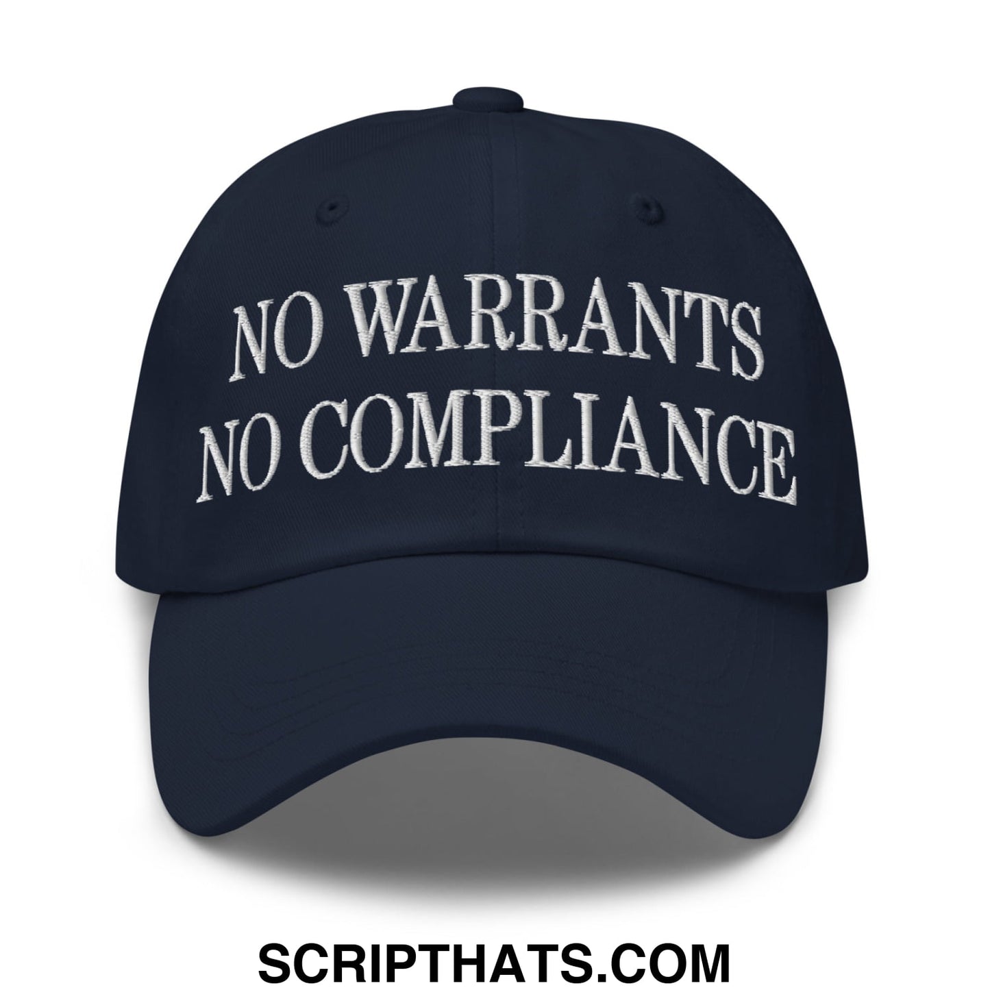 Navy blue unstructured dad hat with white embroidered text no warrants no compliance featuring cotton material