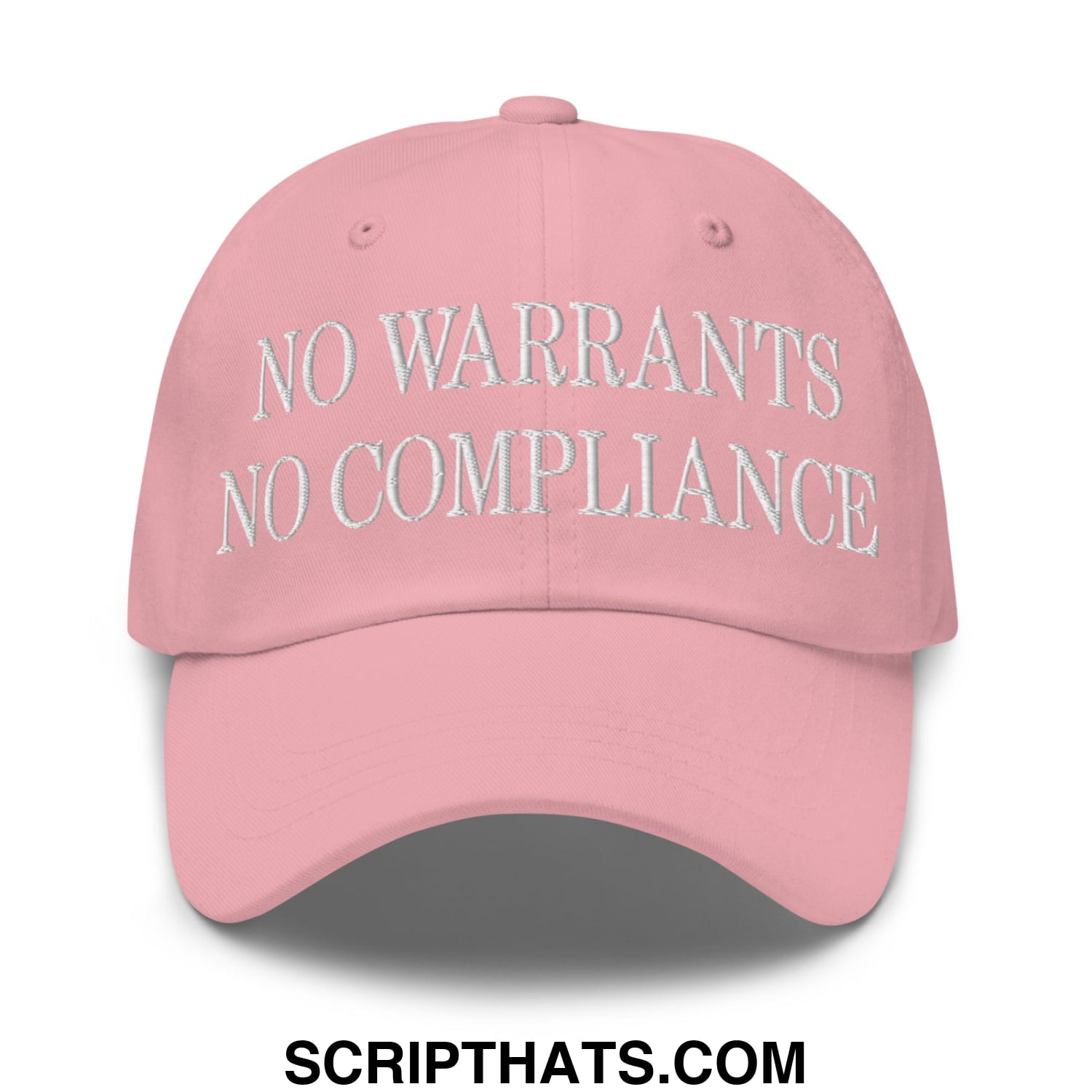 A soft pink unstructured dad hat with white embroidered text no warrants no compliance on the front