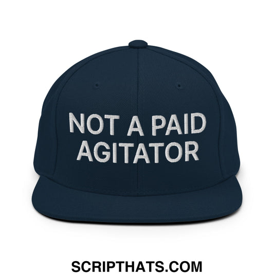 Navy blue snapback hat with white embroidered not a paid agitator text and a flat bill brim design