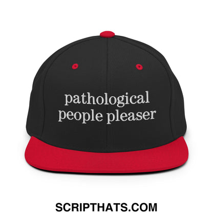Black and red snapback hat with white embroidered pathological people pleaser text flat bill brim design