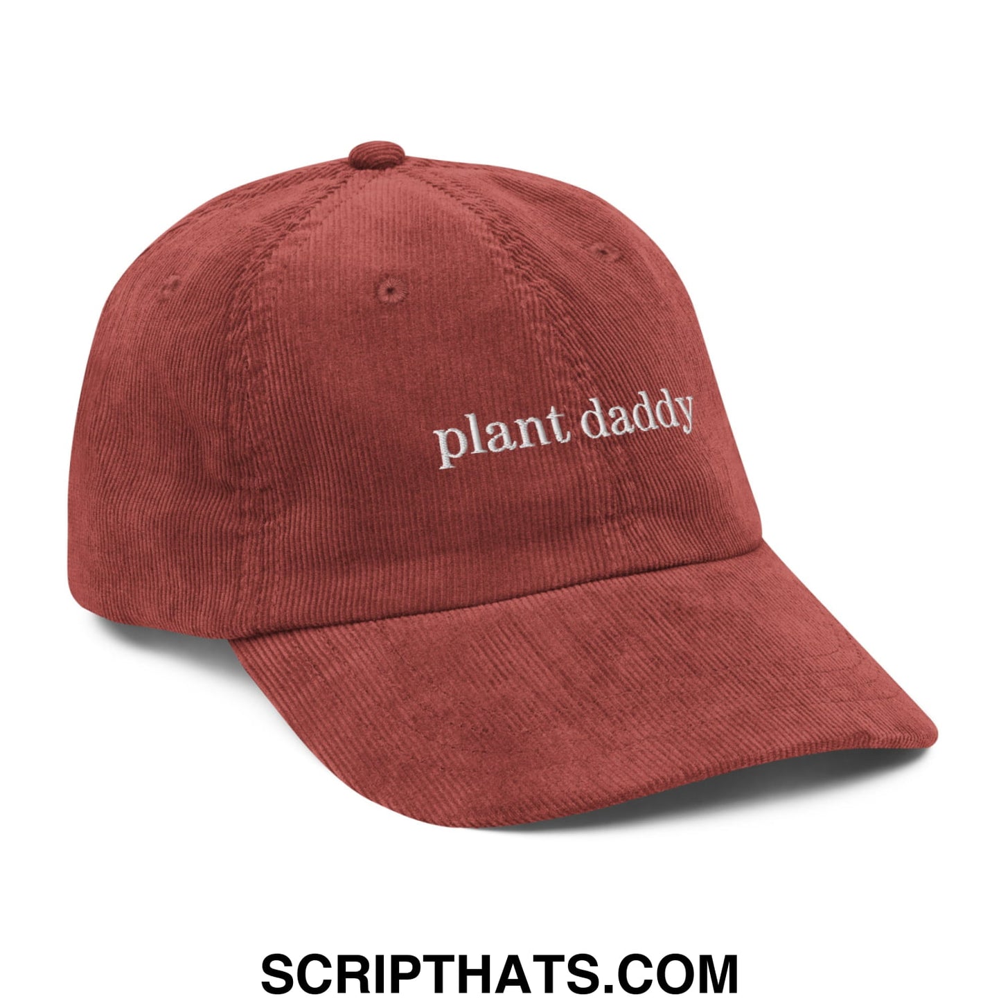 A rust-colored unstructured corduroy dad hat with plant daddy embroidered in white thread across the front