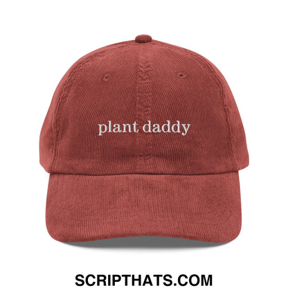 A rust-colored corduroy dad hat with plant daddy embroidered in white thread on the front panel