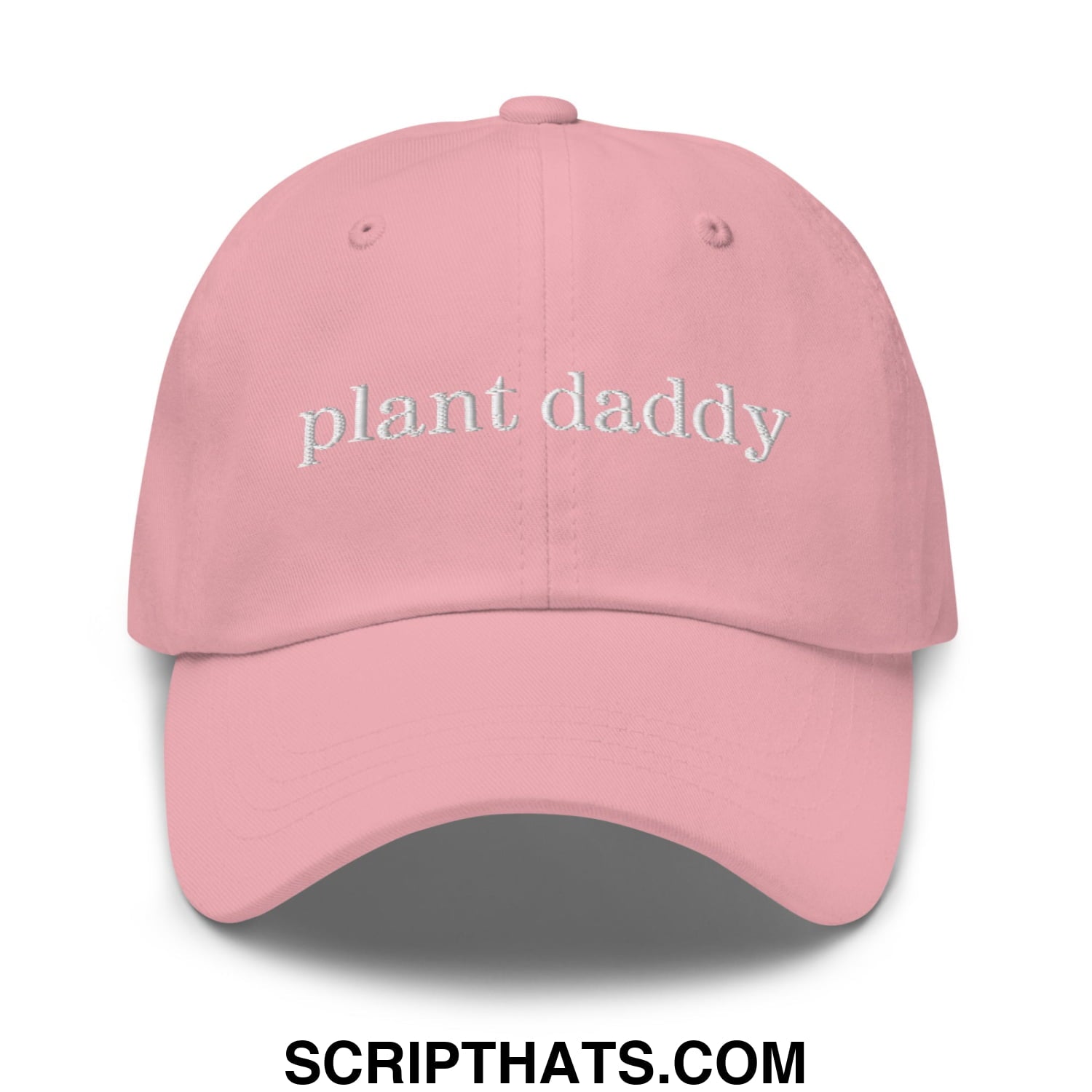 A soft pink unstructured dad hat with plant daddy embroidered in white thread across the front