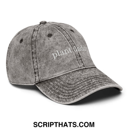 A faded gray denim unstructured dad hat with plant daddy embroidered in white thread on the front