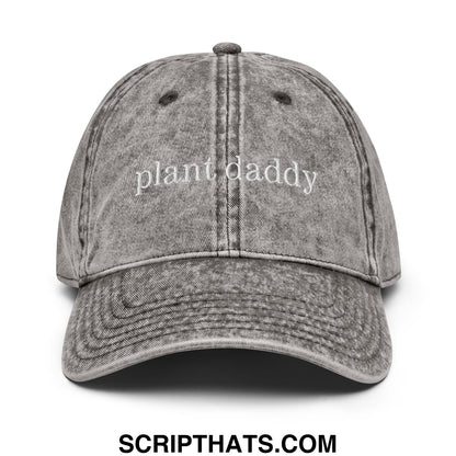 A faded gray unstructured denim dad hat with plant daddy embroidered in white script on the front