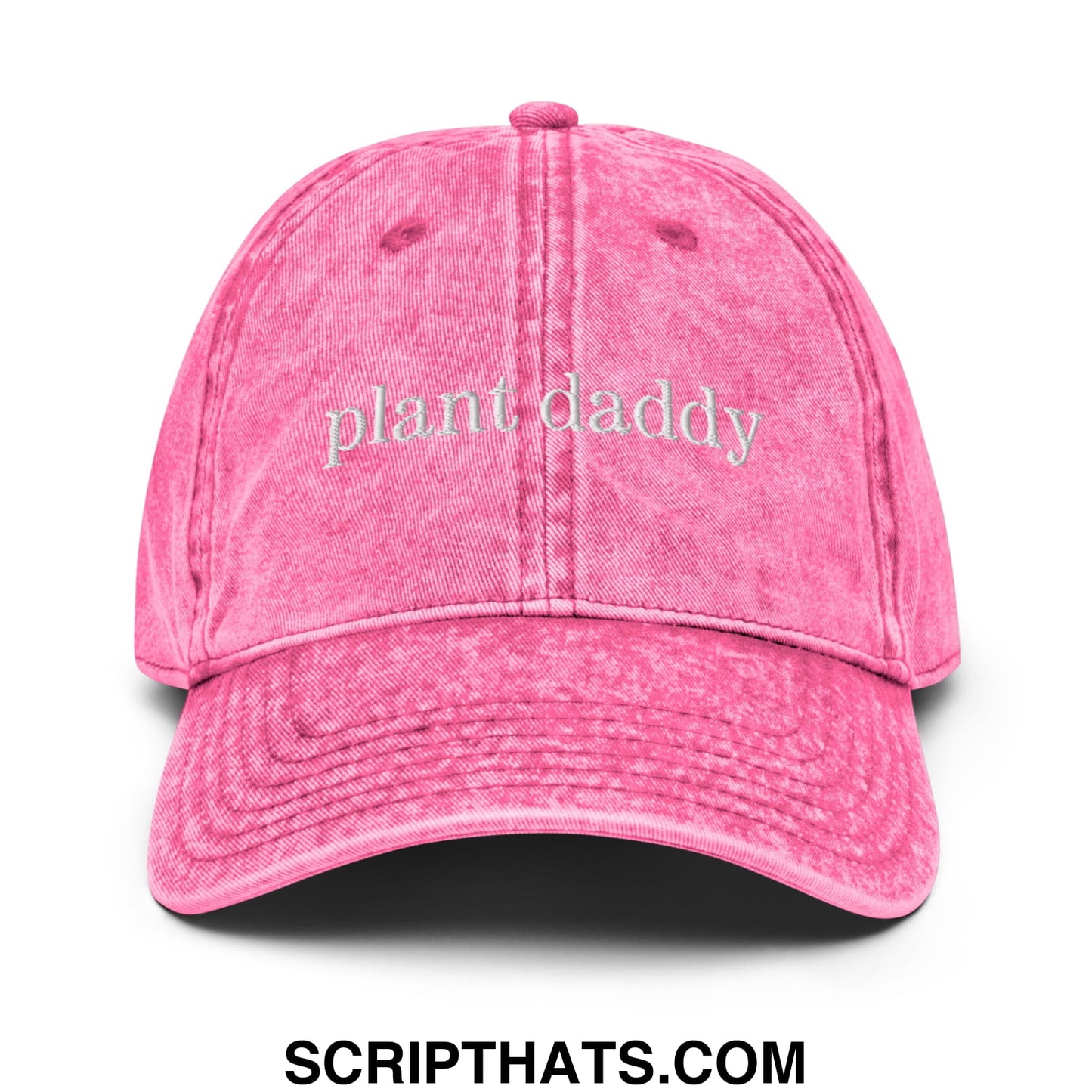 A vibrant pink distressed denim dad hat with plant daddy embroidered in light gray script on the front
