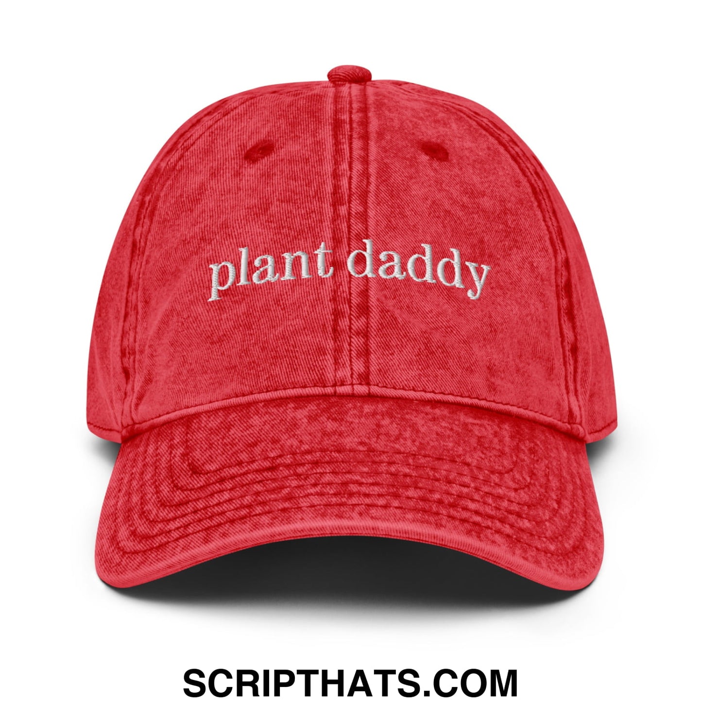 A red distressed cotton baseball cap with plant daddy embroidered in white on the front in an unstructured denim dad hat style