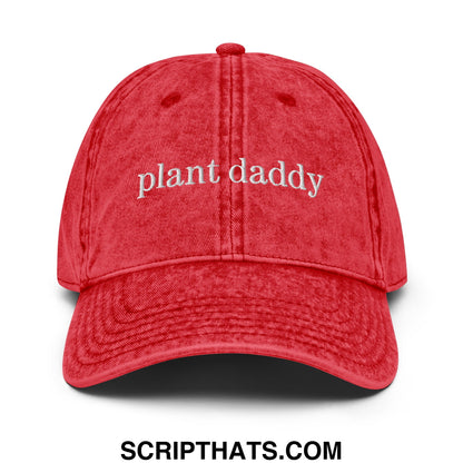 A red distressed cotton baseball cap with plant daddy embroidered in white on the front in an unstructured denim dad hat style