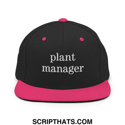 Black snapback hat with vibrant pink flat bill and plant manager embroidered in white thread on front panel