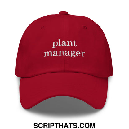 A vibrant red unstructured dad hat with plant manager embroidered in white thread across the front