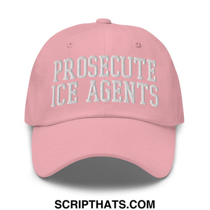 A soft pink unstructured dad hat with prosecute ice agents embroidered in white thread on the front