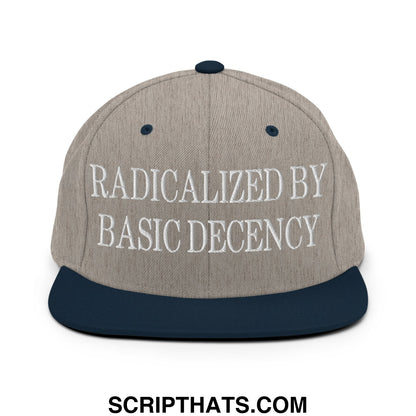 A beige and navy blue snapback hat with white embroidered text radicalized by basic decency on the front panel