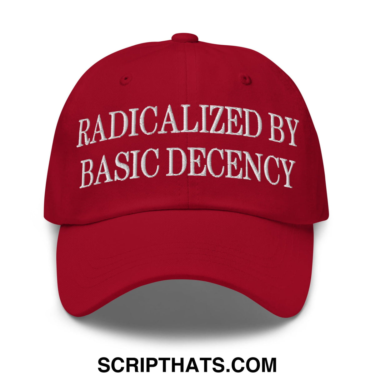 Red unstructured dad hat with white embroidered text radicalized by basic decency on front panel