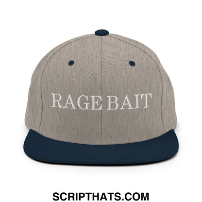 A gray and navy blue snapback hat with rage bait embroidered in white on the flat bill brim