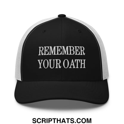 Black and white mesh trucker hat with remember your oath embroidered in silver thread on the front panel