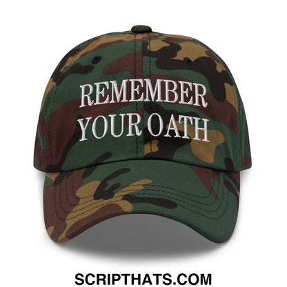 A camouflage unstructured dad hat with white embroidered text reading remember your oath on the front