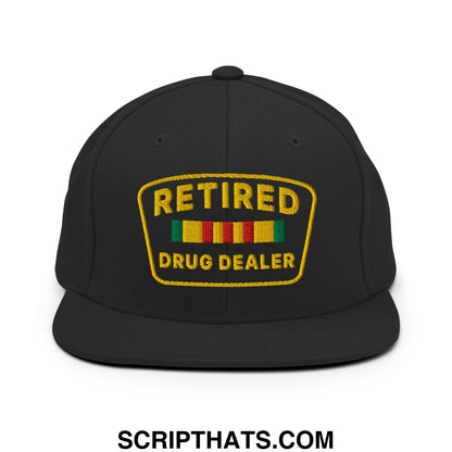 Black snapback cap with gold embroidered retired drug dealer patch and colorful striped ribbons on flat bill brim