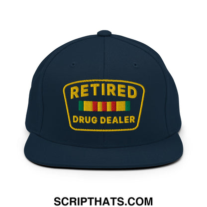 Dark navy blue snapback hat with a bold yellow embroidered retired drug dealer patch and colorful striped ribbon design