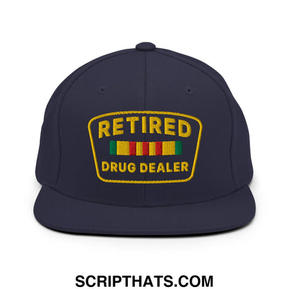 Navy blue snapback hat with gold embroidered retired drug dealer patch and colorful striped ribbon details