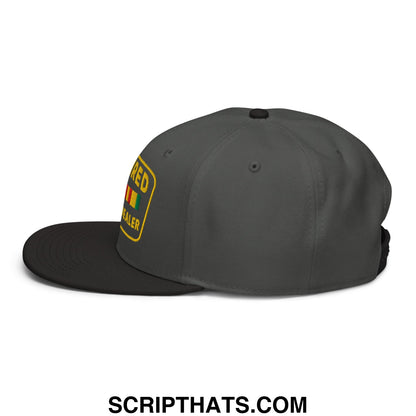Dark gray snapback cap with black brim and yellow embroidered patch red dealer above rastafarian flag design