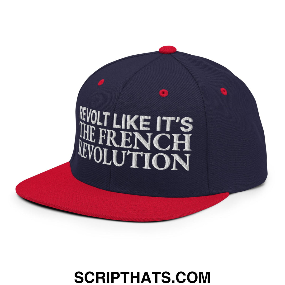 Navy blue and red snapback cap with white embroidered text reading revolt like it’s the french revolution