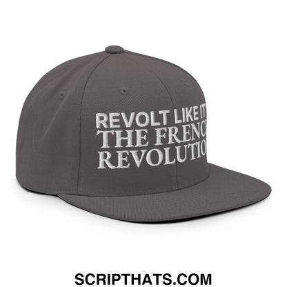 Gray snapback hat with white embroidered text reading revolt like it the french revolution on flat bill brim