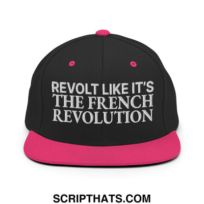 Black snapback cap with vibrant pink brim and button featuring white embroidered text revolt like it’s the french revolution