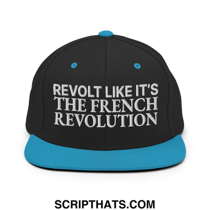 Black snapback cap with teal brim and button featuring white embroidered revolt like it’s the french revolution text