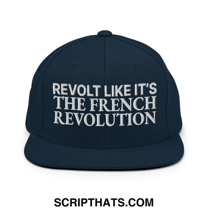 Navy blue snapback hat with white embroidered revolt like it’s the french revolution text and flat bill brim