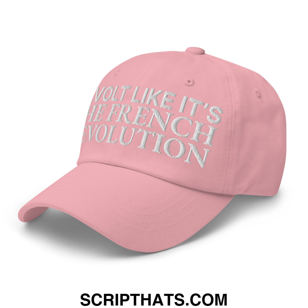 A soft pink unstructured dad hat with silver embroidered text reading revolt like it’s the french revolution