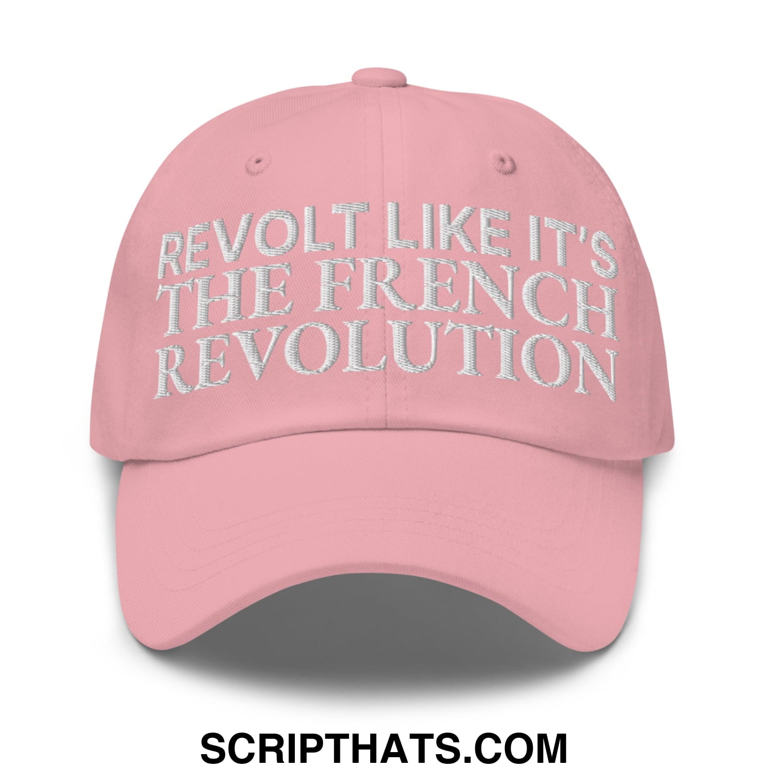 A soft pink unstructured dad hat with white embroidered text reading revolt like it’s the french revolution
