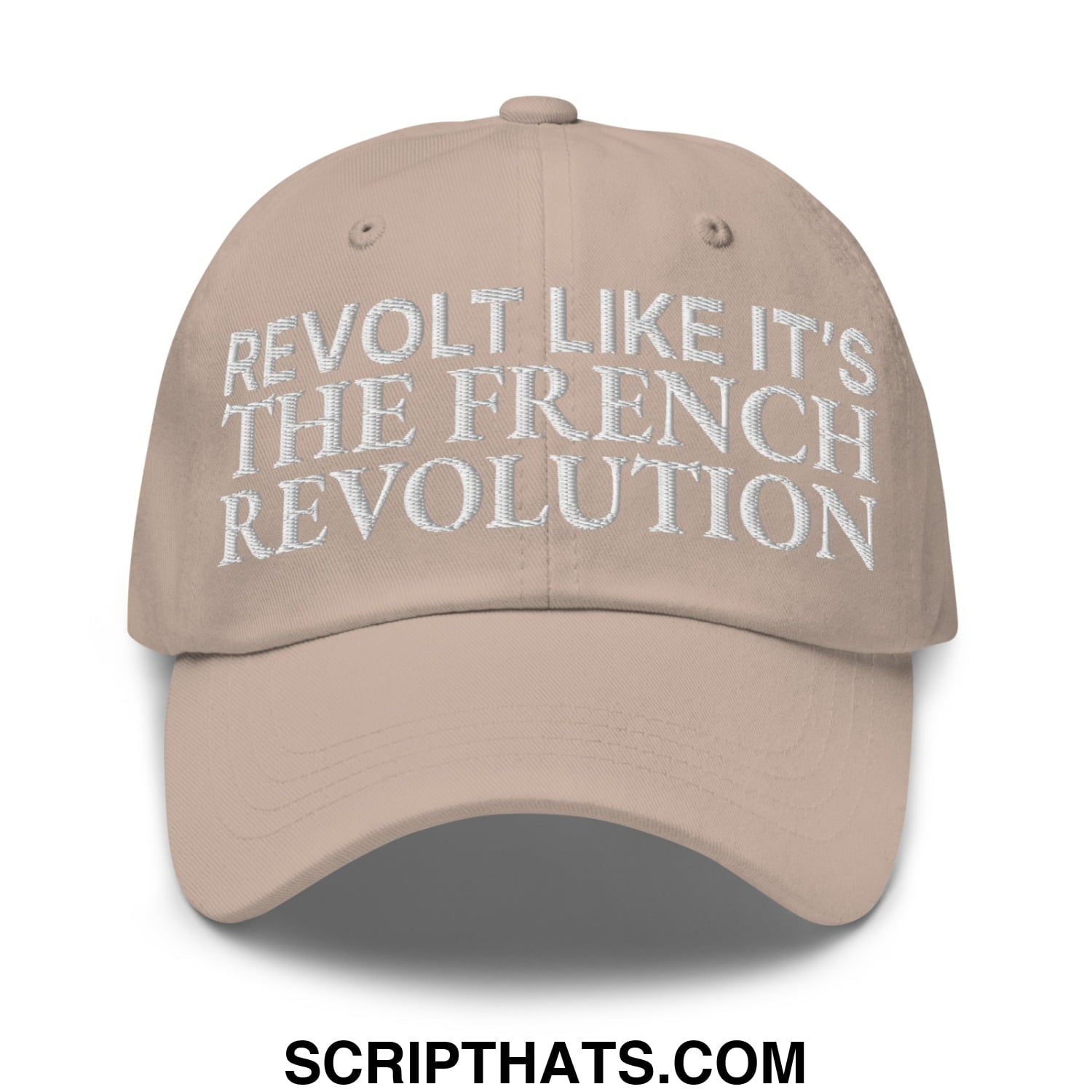 Beige unstructured dad hat with white embroidered text reading revolt like it’s the french revolution