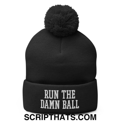 Black knit beanie with fluffy black pom pom and white embroidered run the damn ball text on cuff