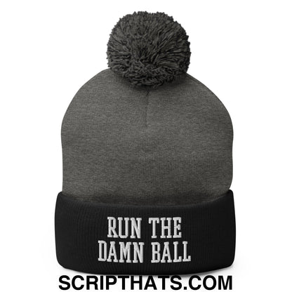 Gray knit beanie with black cuff featuring white embroidered run the damn ball text and gray pom pom on top