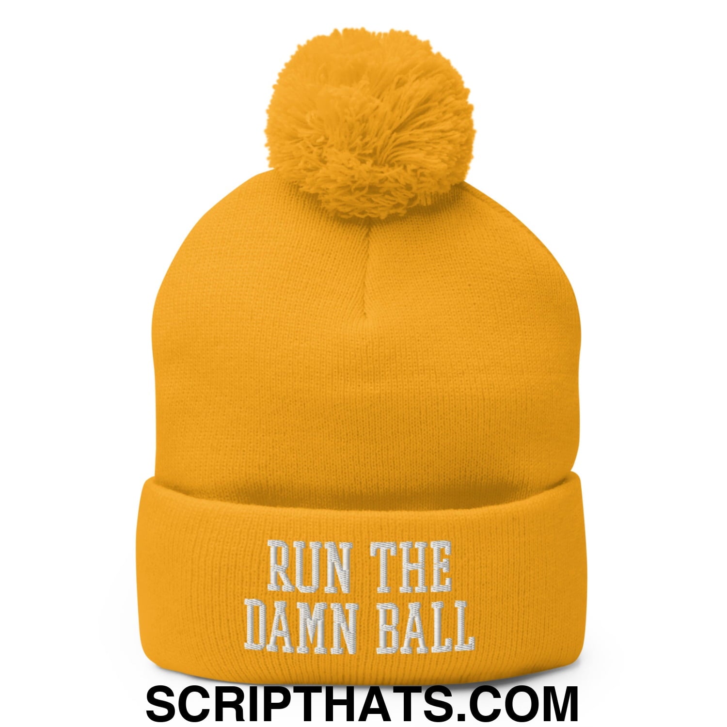 A vibrant yellow knit beanie with a fluffy pom pom and white run the damn ball embroidered text on the cuff