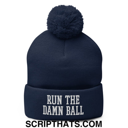 Navy blue knit beanie with matching pom pom and white embroidered run the damn ball text on the cuff