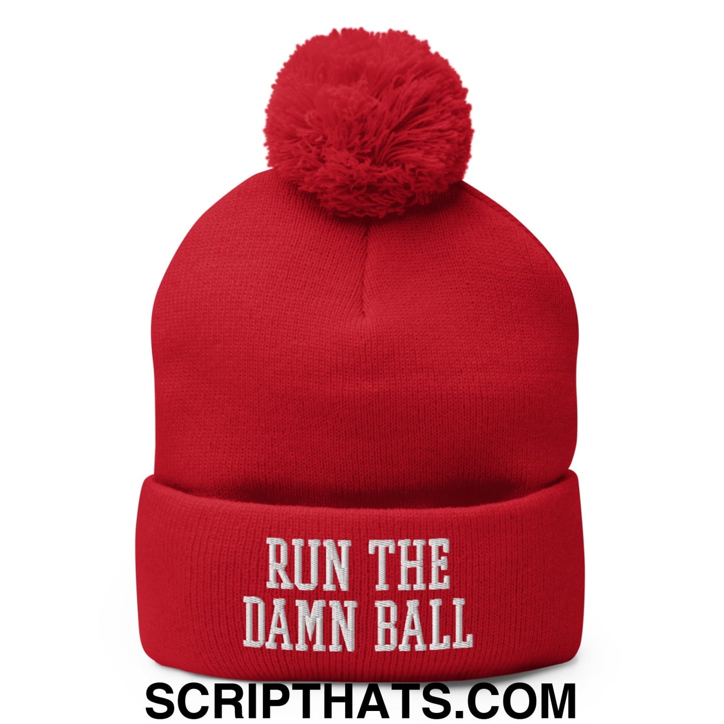Red knit beanie with a fluffy pom pom and white embroidered run the damn ball text on the cuff