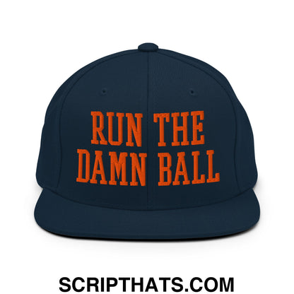 Navy blue snapback hat with bold orange embroidered text run the damn ball and flat bill brim design