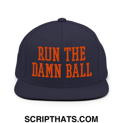 Navy blue snapback hat with bold orange embroidered run the damn ball text and flat bill brim